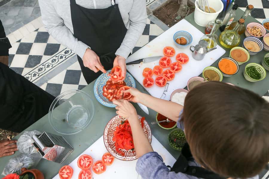 Marrakech: 3-Hour Open-Air Moroccan Cooking Course - Preparing the tagine over the fire